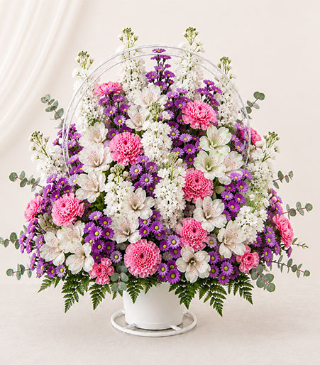 Mixed flowers in a handled basket